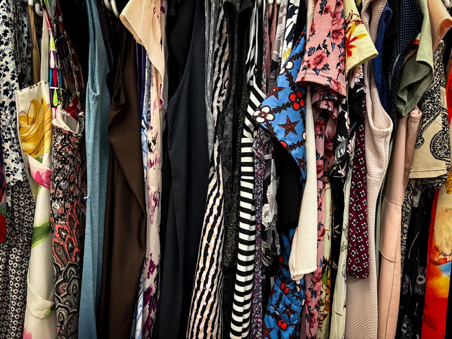 A colourful rack of vintage clothing selected for a new wardrobe